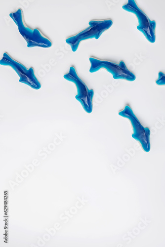 Blue gummy sharks, sweet candies on white background,