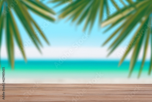 Fototapeta Naklejka Na Ścianę i Meble -  Summer beach party vibes with an empty wooden table and palm leaves against a blurred beach background. Perfect for summer time celebrations