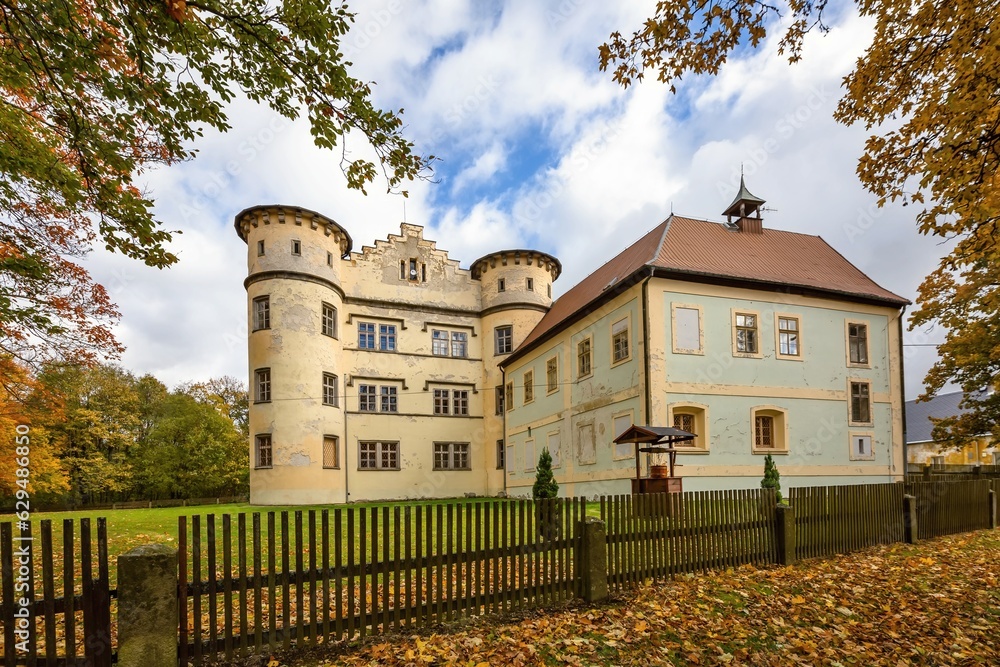 Jindrichovice, Sokolov Czech Republic - October 23 2021: View of the former castle, nowadays an archive. Autumn colours, blue sky with white clouds. Orange leaves on the ground.
