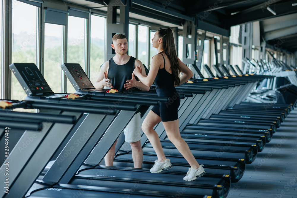A diverse group of people, including both men and women, engaging in a challenging fitness workout with their dedicated male instructor. Sporty Couple Running Outdoors under the Supervision A diverse group of people, including both men and women, engaging in a challenging fitness workout with their dedicated male instructor. Sporty Couple Running Outdoors under the Supervision