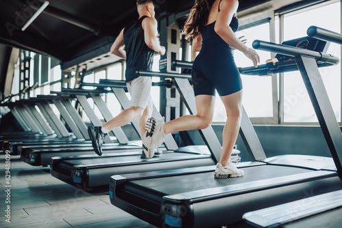 Obraz na płótnie Hispanic and American Couple run treadmill Fitness in the Gym