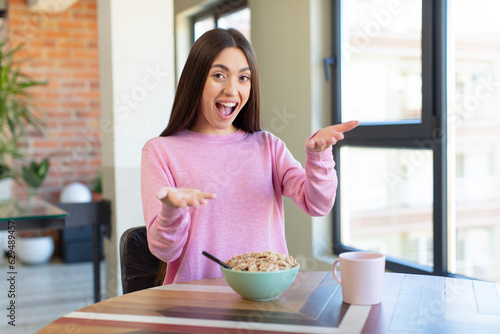 smiling happily and offering or showing a concept. breakfast concept