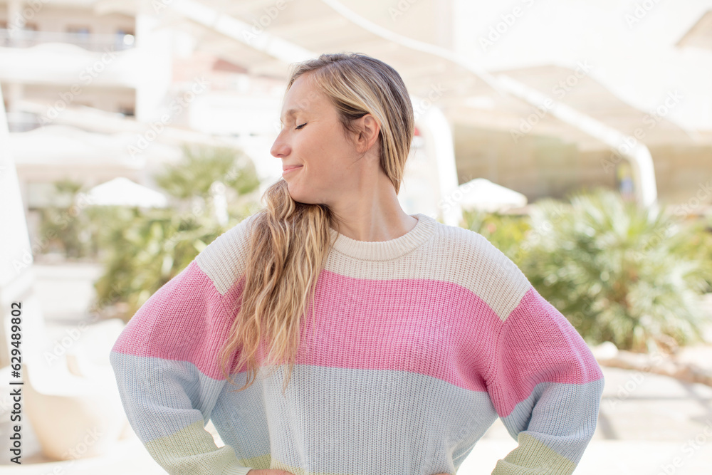 Fototapeta premium pretty woman wondering, thinking happy thoughts and ideas, daydreaming, looking to copy space on side