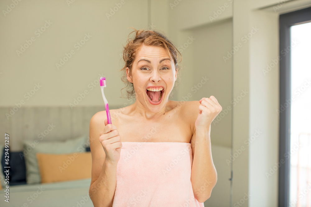 young pretty woman feeling shocked,laughing and celebrating success. mouthwash concept young pretty woman feeling shocked,laughing and celebrating success. mouthwash concept