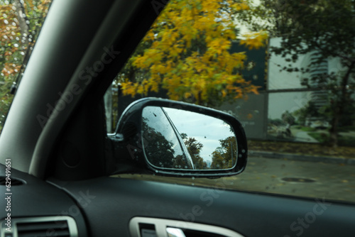 Rearview mirror of a car in rainy weather © Atlas