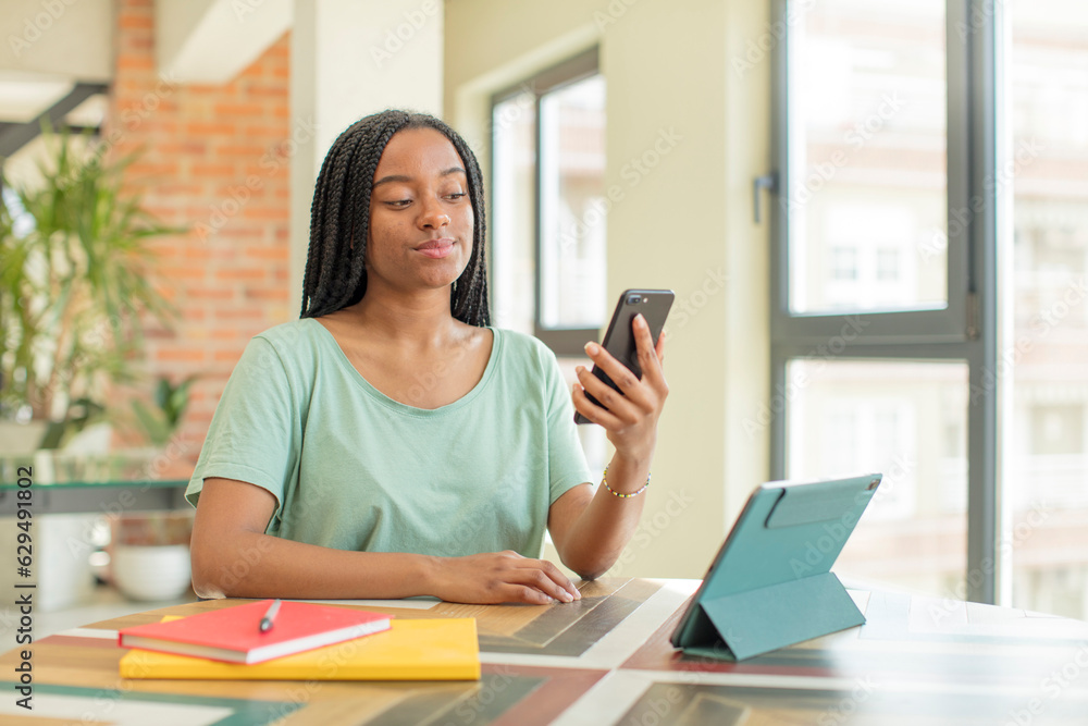 black afro woman smiling and looking with a happy confident expression. studying concept black afro woman smiling and looking with a happy confident expression. studying concept