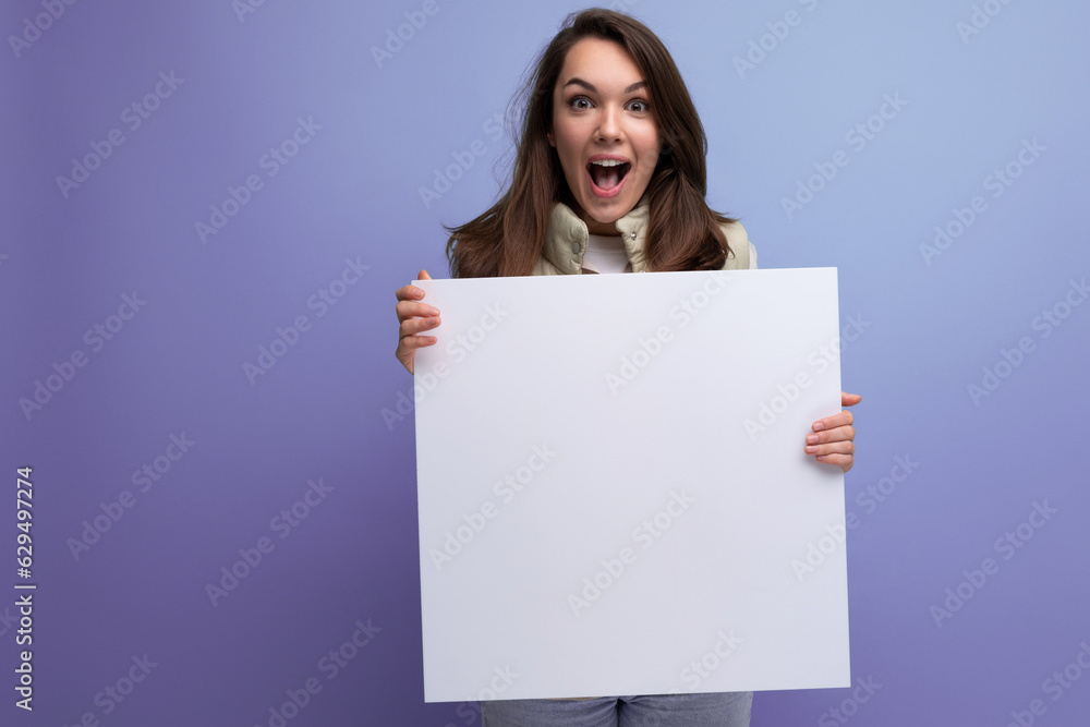 happy young brunette woman holding paper board with mockup happy young brunette woman holding paper board with mockup
