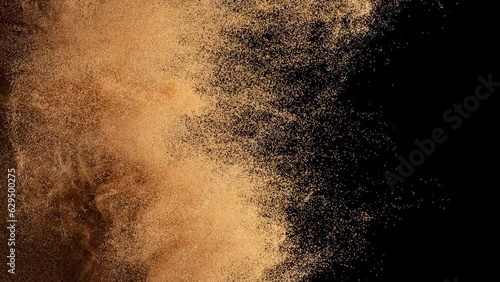 Bronze particles fly on a black background. The wind blows away colored sand. Powder. Spray. Texture. 3d animation.