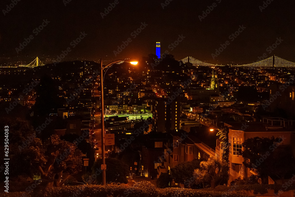 Landmark Coit Tower at night in San Francisco. San Francisco Cityscape at Night Panorama. View of the Coit Tower at night, from Russian Hill, in San Francisco. San Francisco Coit Tower Illuminated in 