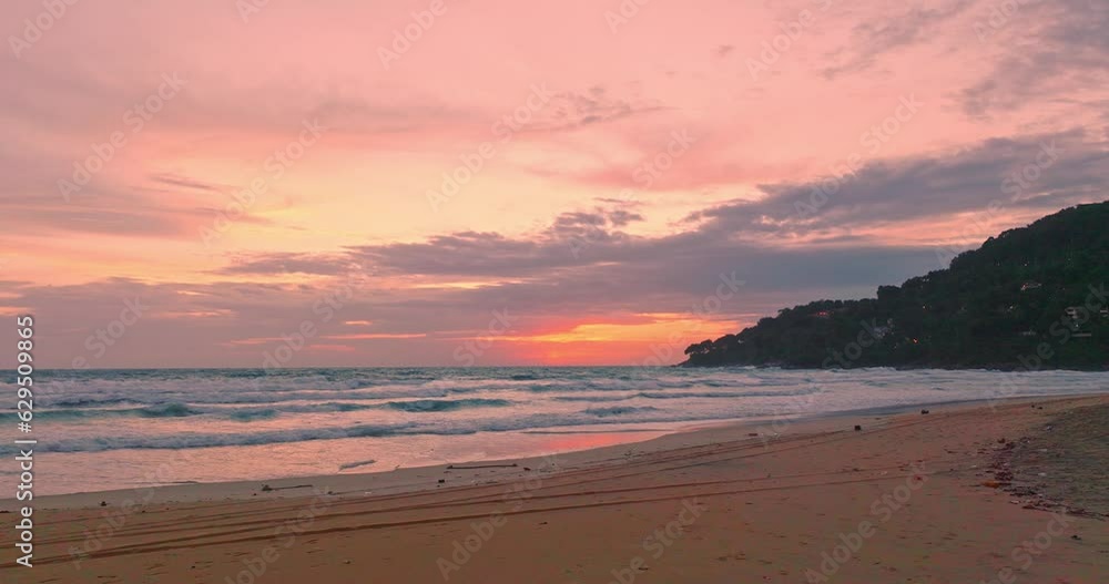 aerial view exotic colorful sky in bright sunset at Karon beach Phuket. .The sea waves crashing onto the beach under a sky of beautiful clouds .amazing sky of bright sunset in nature background. aerial view exotic colorful sky in bright sunset at Karon beach Phuket. .The sea waves crashing onto the beach under a sky of beautiful clouds .amazing sky of bright sunset in nature background.