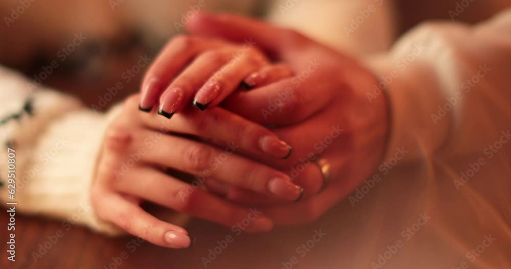 Close-up of the hands of a couple in love sitting at a table in a cafe on a romantic date. Male and female hands interacting with each other at the moment of a romantic meeting of a couple in love. Close-up of the hands of a couple in love sitting at a table in a cafe on a romantic date. Male and female hands interacting with each other at the moment of a romantic meeting of a couple in love.