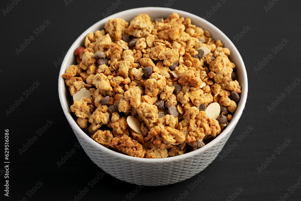 Protein Granola with hazelnut, almond, and chocolate in a Bowl, side view.