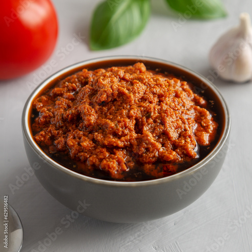 Homemade Sun Dried Tomato Pesto in a Bowl, side view. Copy space.