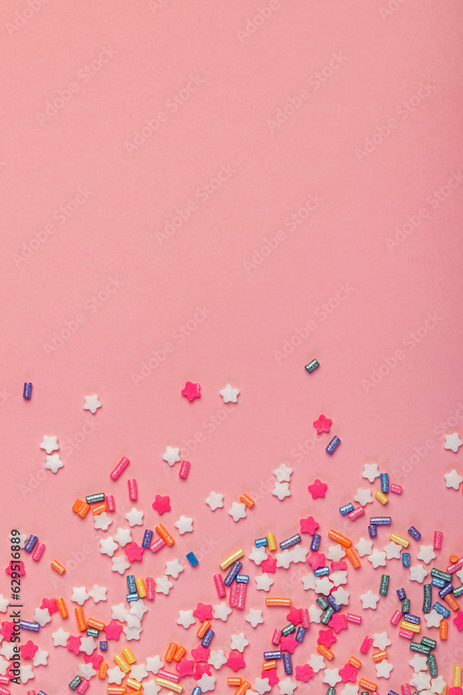 Colorful star shaped sugar sprinkles on pink background Colorful star shaped sugar sprinkles on pink background