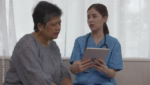 Asian Female Nurse Providing Health Information Using Tablets