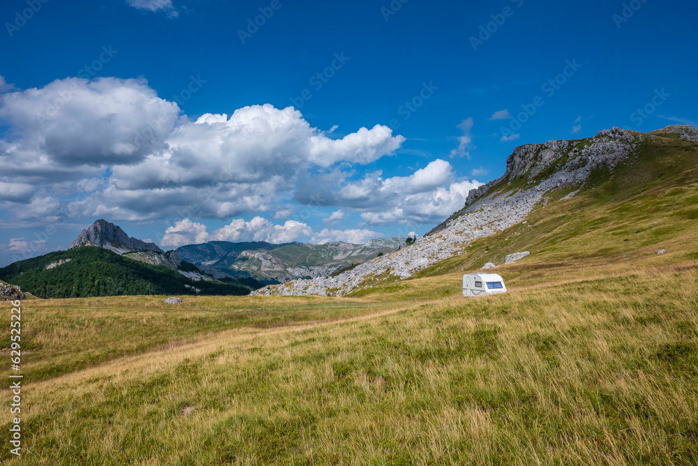 Lonely camping house on a mountain meadow in the wild Lonely camping house on a mountain meadow in the wild