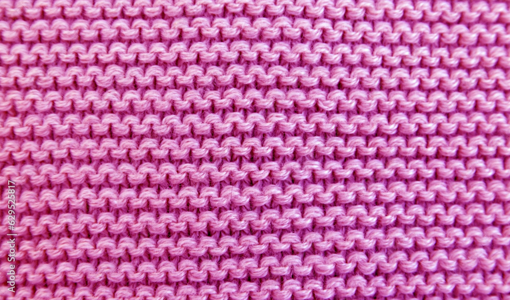 Close up background of knitted pink wool fabric knitwear texture. Close up background of knitted pink wool fabric knitwear texture.