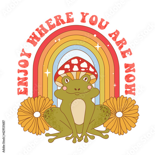 Retro 70s groovy funky frog with mushroom, flowers and rainbow. Enjoy where you are now slogan print with frog character wearing mushroom hat. Naive groovy psychedelic vintage illustration.