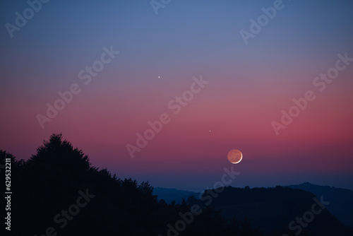Crescent Moon, planet conjunction and landscape scenery silhouettes.