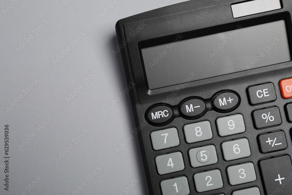 Calculator on gray background, top view. Space for text Calculator on gray background, top view. Space for text