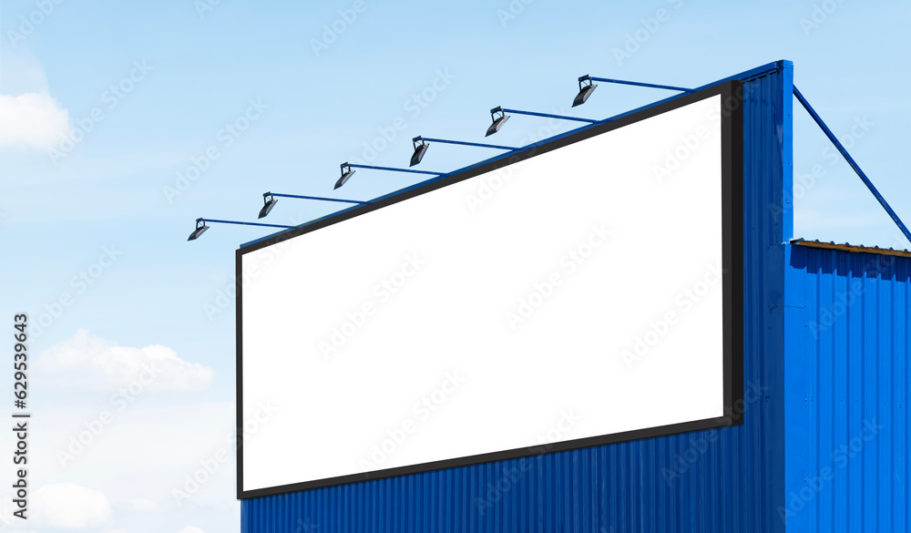 Mock up white background billboard on blue building with spot light Mock up white background billboard on blue building with spot light