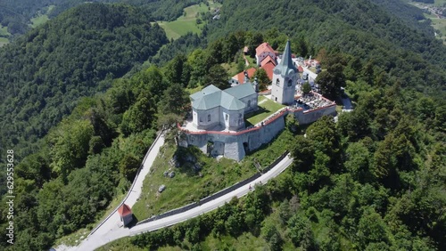  A drone view of an old church located on a hill. Camera slowly moves away from the subject. Zasavje Holy Mountain, The Mary’s Nativity Church photo