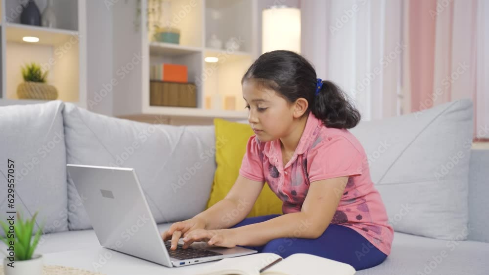 Negative expression of girl child using laptop. Negative expression of girl child using laptop.