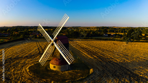 Windmill over fields and farms from a drone, Torquay, Devon, England photo