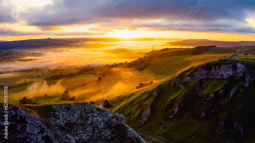 Amazing view in Brecon Beacon national park, Wales, United Kingdom. Dragons Back ridge in the Black Mountains at sunset. Welsh Countryside with Cloud and Mist over Mountains and Hilltop.  photo