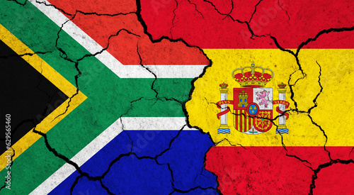 Flags of South Africa and Spain on cracked surface - politics, relationship concept
