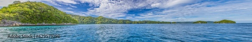 Panoramic view over turquoise blue water to a tropical island in Palau