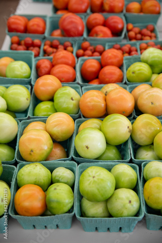 green tomatoes in cardboard baskets