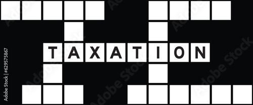 Alphabet letter in word taxation on crossword puzzle background