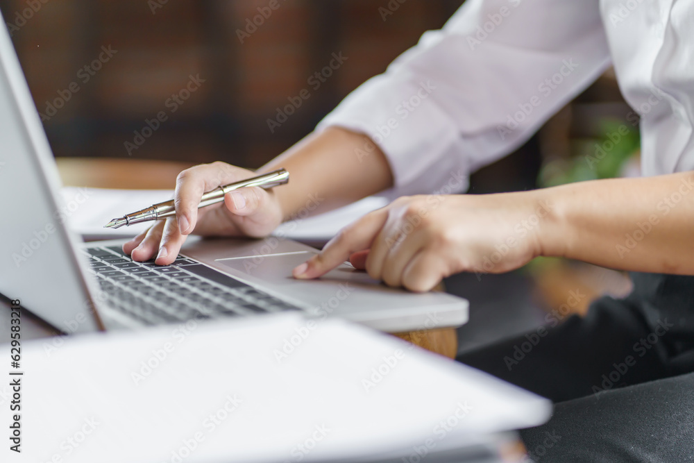 Happy young Asian Woman working on computer Business Data Analyst.