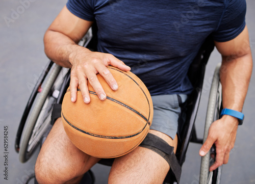 Wheelchair, basketball and man hand with sports ball outdoor for fitness, training and cardio. Exercise, hobby and top view of male with disability ready for game, workout and fun or active match