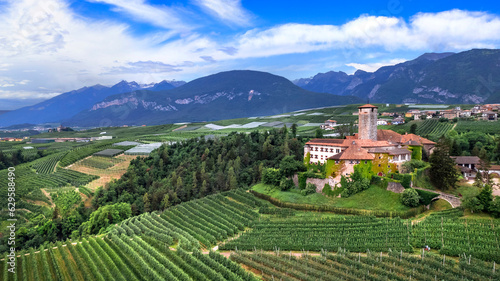 Medieval beautiful castles of northern Italy  - scenic Valer castel amongst the apple trees of Val di Non. Trentino region  Trento province.  Aerial drone panoramic view