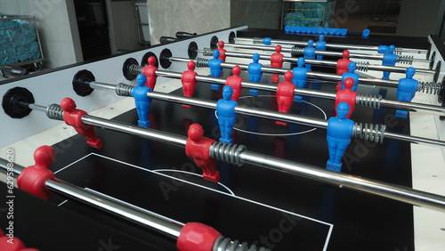 Football table or soccer table game with plastic player figurine. Mini Soccer game which famous in past and be collectable item for foosball lover. Play by two hand control each row of player figurine © gnepphoto