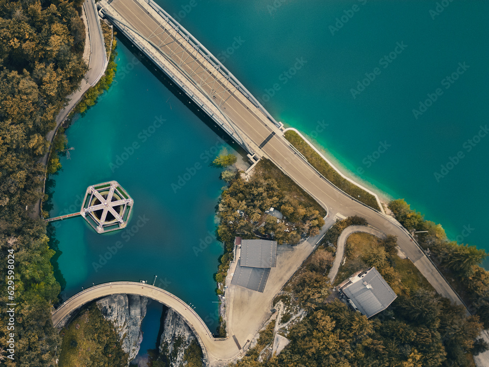 Aerial shot of Barcis lake and its dam. Emerald water, sky with clouds