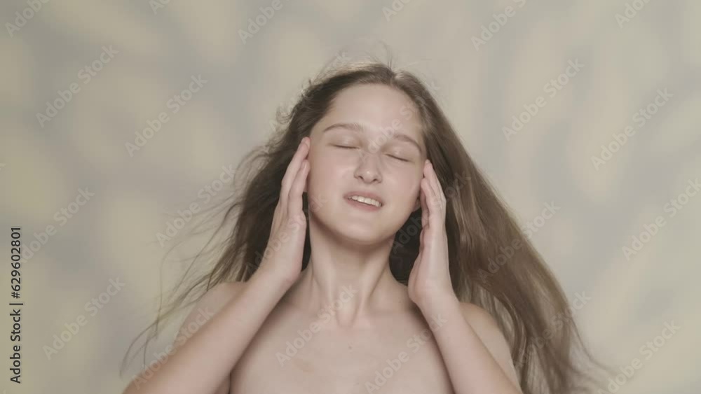 Beautiful young girl with natural makeup and silky long hair, looking at the camera. Slow motion HDR BT2020 HLG Material. Beautiful young girl with natural makeup and silky long hair, looking at the camera. Slow motion HDR BT2020 HLG Material.