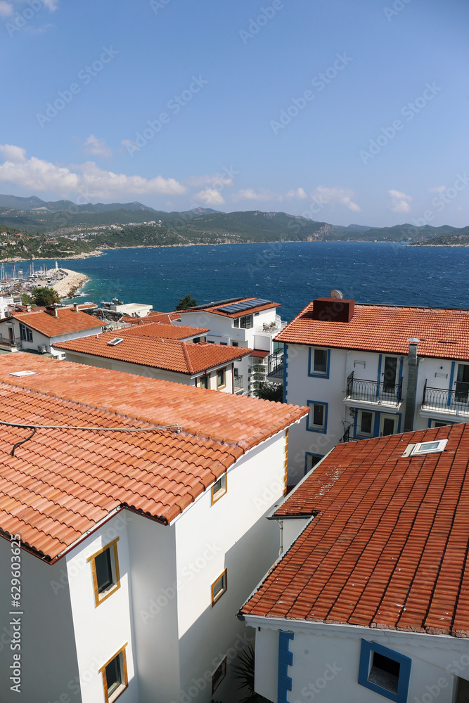Red shingle roof tops of old town on the coast of mediterranean sea. Top view, copy space, background.