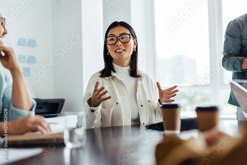 Business woman having a discussion with her team in an office