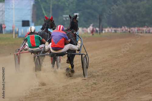 Horses and riders running at horse races
