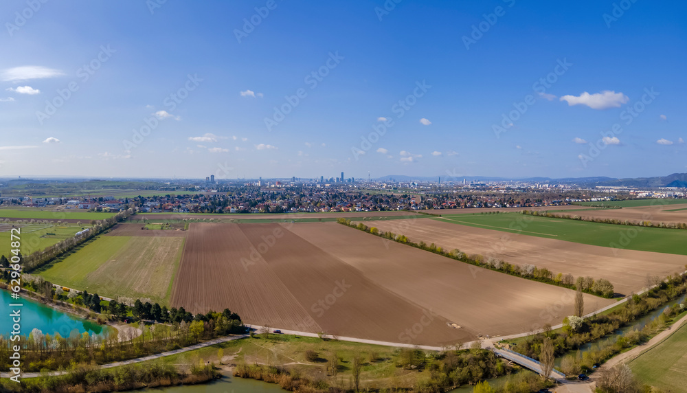 Aerial drone panoramic view of farmland and district 22, Donaustadt, Vienna in the distance, Gerasdorf, Lower Austria, Austria. Aerial drone panoramic view of farmland and district 22, Donaustadt, Vienna in the distance, Gerasdorf, Lower Austria, Austria.
