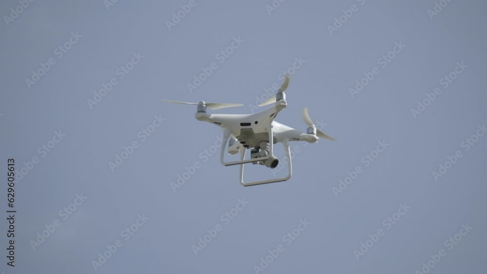 Filming drone flying in a blue sky Filming drone flying in a blue sky