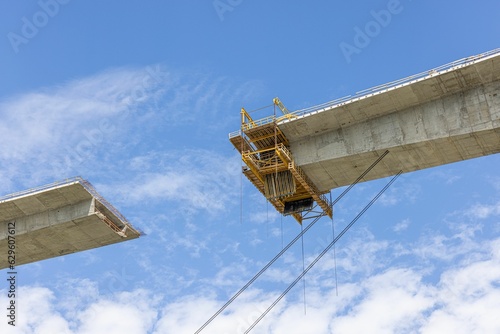 Low angle shot of a bridge under the construction under a blue cloudy sky in Bosnia and Herzegovina