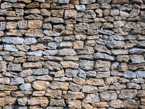 Outdoor stone wall composed of assorted sizes of rocks