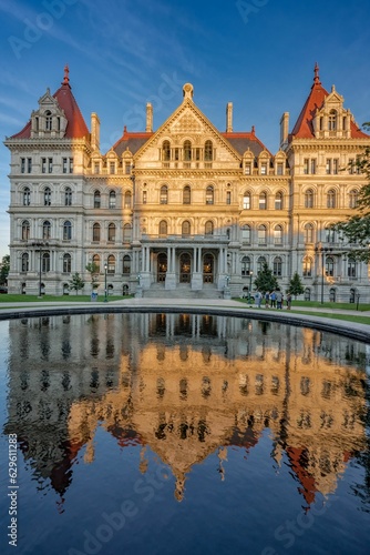 New York state capitol in Albany reflected in water at sunset © J  Liu/Wirestock Creators
