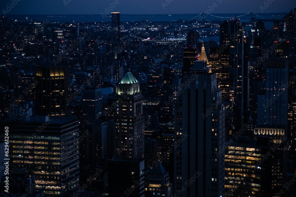 Obraz premium Aerial view of the illuminated New York City skyline at night