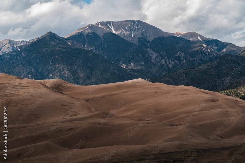 Great Sand Dunes National Park, featuring sandy dunes with a mountain and sky backdrop