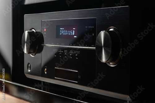 Modern, black audio video receiver with a glossy finish and minimalistic design